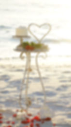 wedding cake and table setup on the beach with ocean view