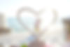 Couple standing inside of heart on beach