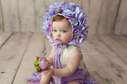 baby girl and purple flowers