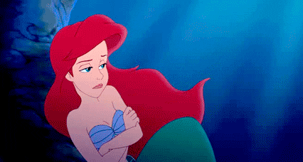 Ariel from The Little Mermaid sighing with arms crossed
