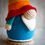 Thumbnail: handmade crochet rainbow gonk. Blur body and rainbow hat.