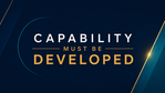 Graphic banner with the words “Capability must be developed” in white and gold on a dark navy background with teal and gold geometric accents.