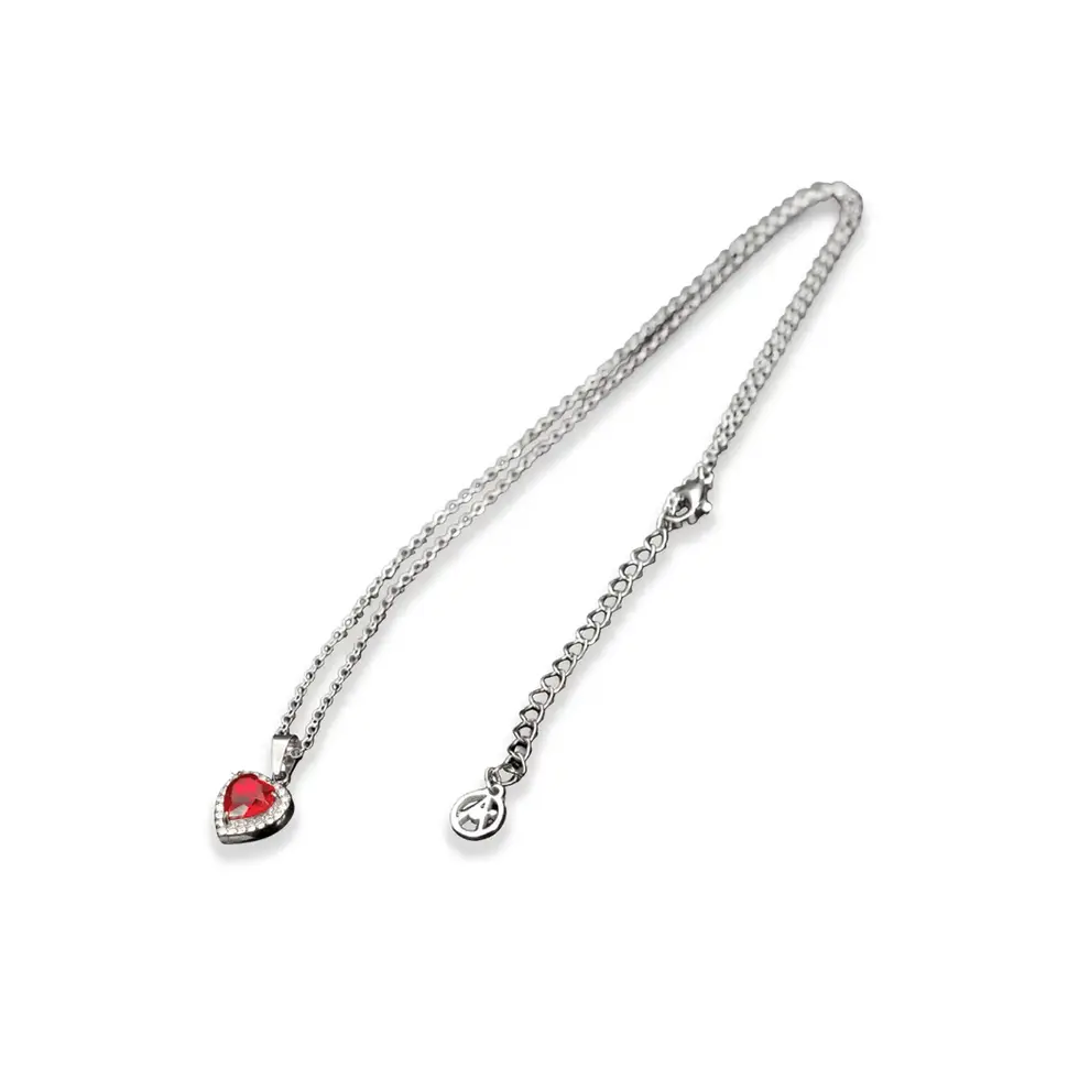 Silberfarbene Edelstahl-Halskette diagonal gelegt, roter Herz-Zirkon links unten, Verlängerung rechts. Avirelle.