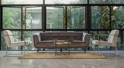 Lobby seating area at B2 Huai Khwang Premier Hotel with full-height glazing, contemporary furniture, and daylight-oriented interior design.