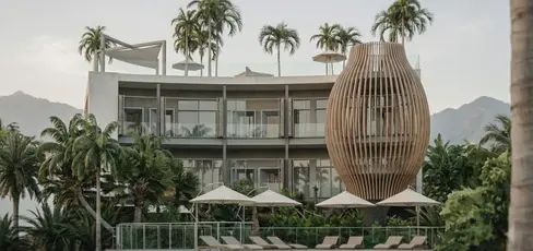 Guestroom block elevation at Samui One Resort with continuous balconies, shading strategy, pool-facing amenity edge, and sculptural timber screen.