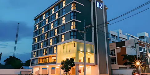 Night view of B2 Khon Kaen Wufoo Market Premier Hotel showing illuminated lobby corner, restrained façade lighting, and integrated B2 signage.