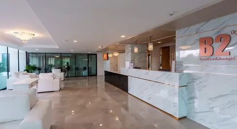 Lobby seating and circulation space at B2 Rayong Boutique & Budget Hotel with modern furniture and glazed façade.