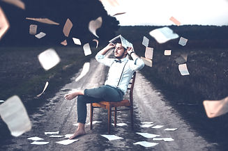 man%20sitting%20on%20chair%20with%20book_edited.jpg