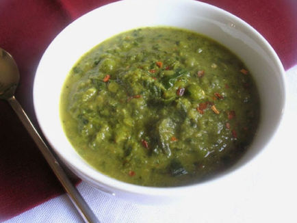 A white bowl filled with green gumbo