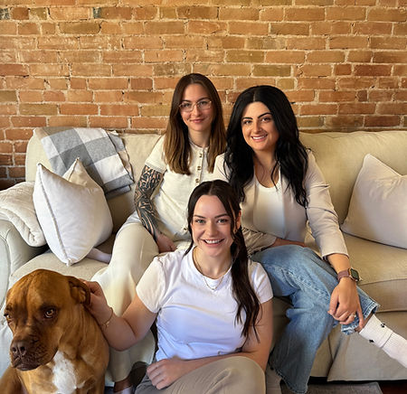 Alex, Jessica, Claire, and Pixie smiling warmly on Fairapy's cozy couch 