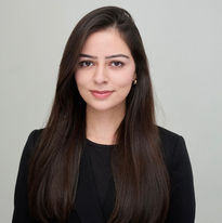 Captured in a moment of calm focus, Ayesha's portrait reflects her ability to hold space for clients with both presence and therapy.
