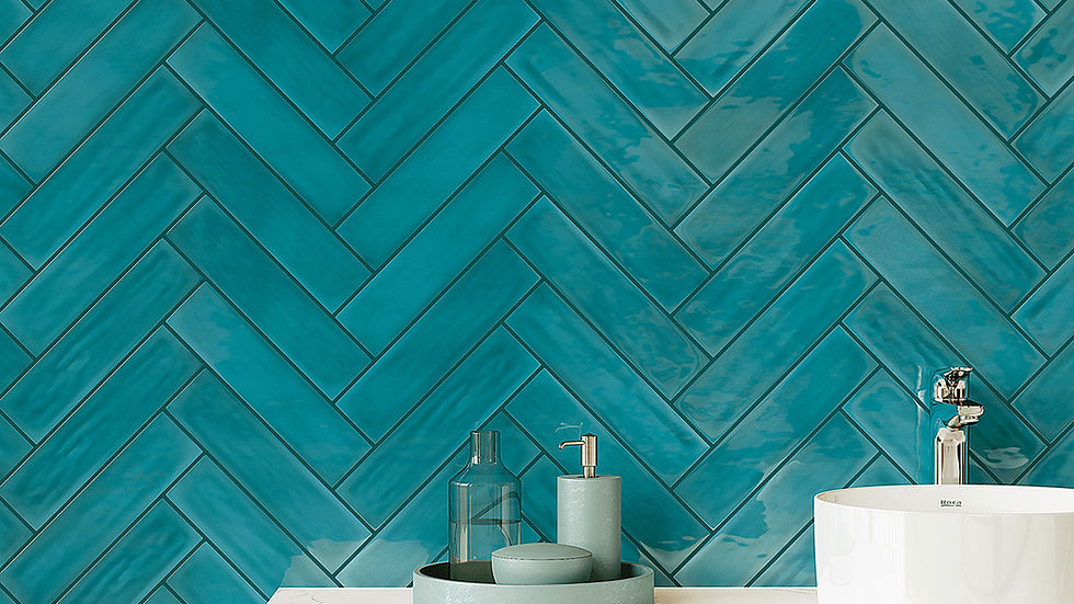 White sink on a floating marble shelf with teal bathroom accessories. Background: glossy teal herringbone tiles. Minimalist and sleek.