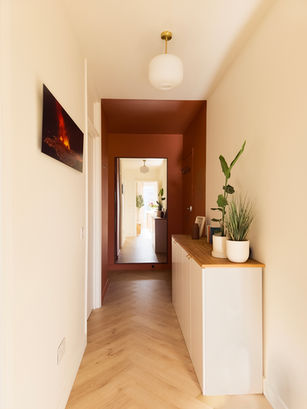 VIEW ONTO HALLWAY WITH HERRINGBONE WOODEN FLOORS, OFF WHITE HALL WITH A TERRACOTTA BOX PAINTED ACROSS ENTRANCE WALLS AND CEILING