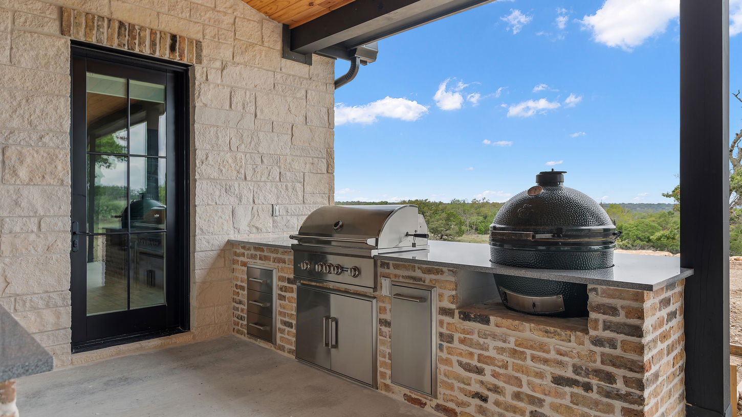 Back patio grilling area sitting along side the smoke grill