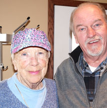 Volunteer and client standing together, smiling
