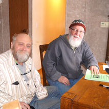 Volunteer and client sorting mail together.