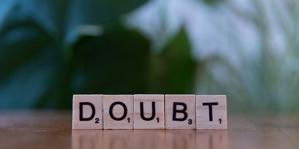 Wooden tiles spelling out 'DOUBT,' illustrating the internal self-doubt experienced by women navigating chronic burnout.