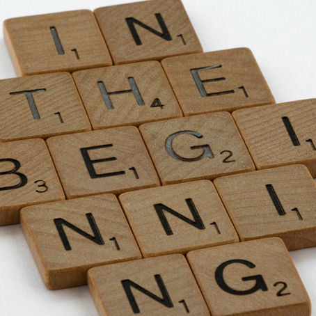 Scrabble letters spelling "In the beginning" with the letters displayed in a 2-3-4-3-2 pattern.