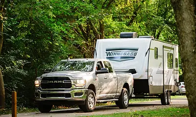 winnebago minnie travel trailerhookedup to a truck for towing.webp
