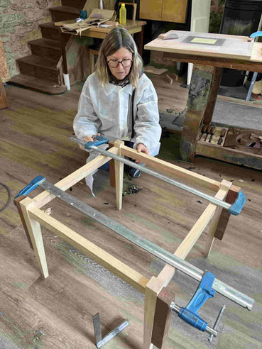 Collage de l'ossature de sa table par une stagiaire à l'atelier ébénisterie d'Isabelle Pilllet ossature réalisée en chêne avec assemblages tenons et mortaises.