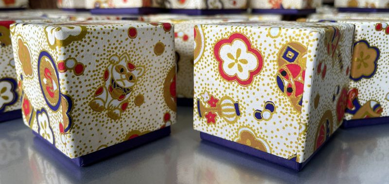 A small box made with Chiyogami paper pattern No. 3826 and purple Torinoko paper.