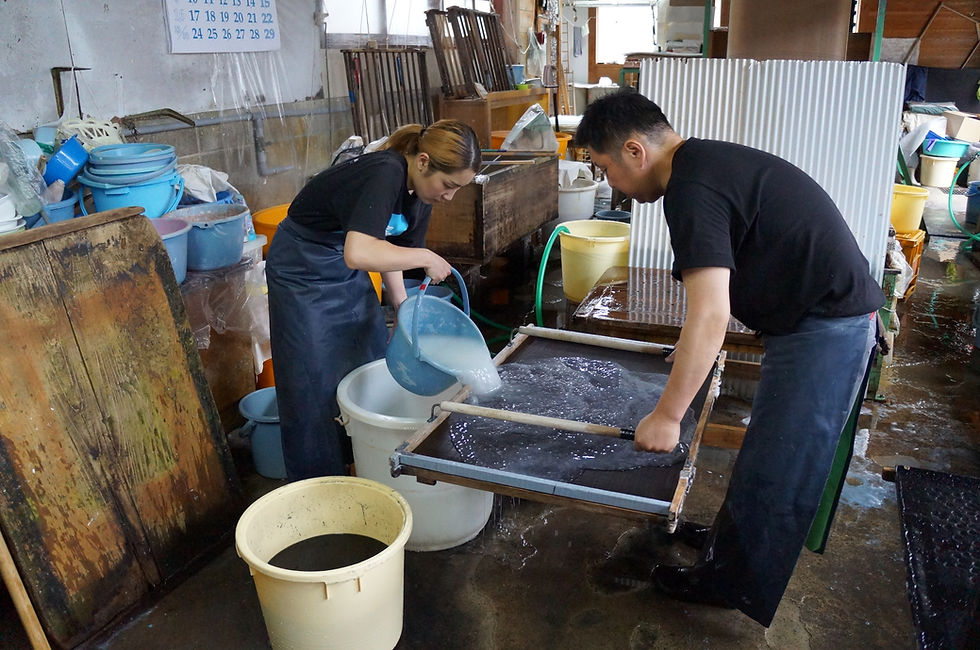 The raw materials for Japanese paper are poured into the mold and the paper is made.