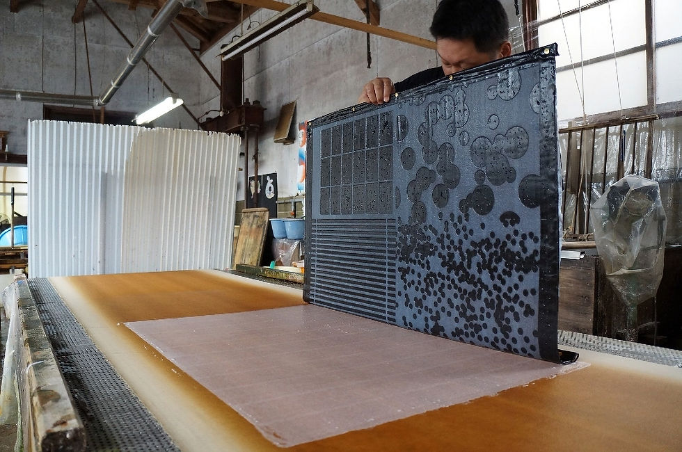 A papermaking technique called "sukikomi" in which two layers of washi paper are joined together to form a single sheet of paper.