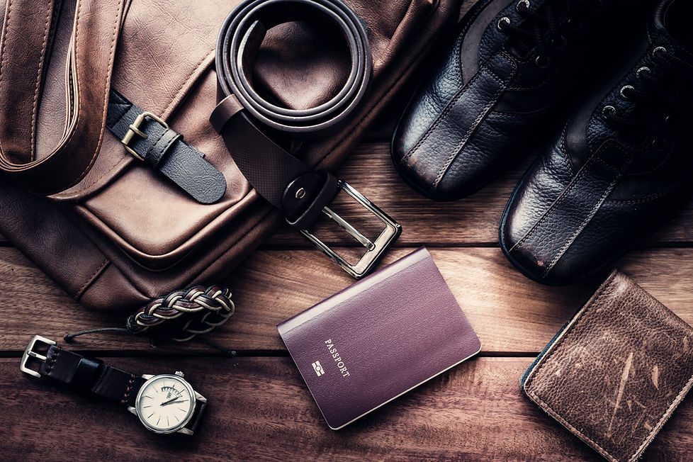 Still life with Men's casual outfits with leather accessories on brown wooden background,