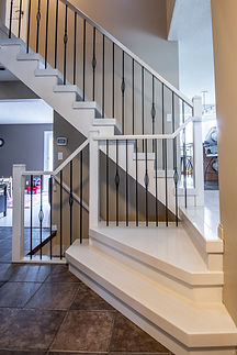 Open rise stairs painted in pearly white with feature spindle pattern.