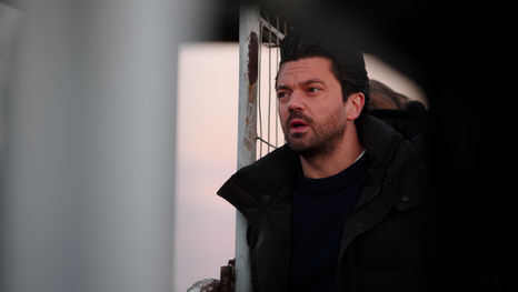 Behind the scenes still from a TV drama production showing camera crew and lead actors on set.