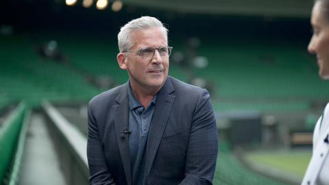 Behind the scenes still from a TV drama production showing camera crew and lead actors on set.