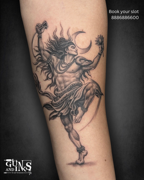 Black and grey Nataraja Shiva tattoo with crescent moon and flowing movement on the leg at Guns and Inks in Hyderabad.