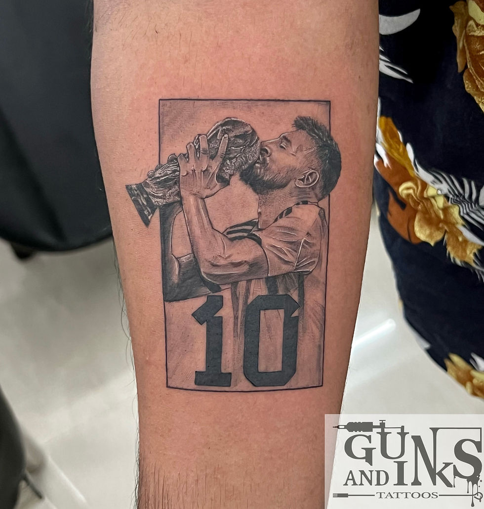 Messi kissing the World Cup tattoo design, a tribute by Guns and Inks, Hyderabad's elite Tattoo and Piercing studio, celebrating a legendary moment in sports.