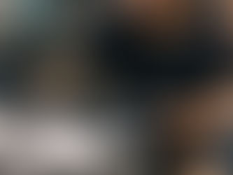 Professional tattoo artist designing a custom tattoo for a client inside a modern hygienic tattoo studio in Hyderabad, India. The artist is carefully sketching a detailed tattoo design in a sketchbook while discussing ideas with the client during a tattoo consultation. The workspace shows organized tattoo equipment, sterile tools, tattoo ink bottles, and a digital tablet displaying tattoo artwork, highlighting the professional setup of a safe and hygienic tattoo studio. The tattoo artist is wearing protective gloves and working under bright studio lighting, reflecting strict hygiene and safety standards followed by experienced tattoo artists. This scene represents the custom tattoo design process at Guns and Inks Tattoos & Piercings, one of the best tattoo studios in Hyderabad known for professional tattoo artists, safe tattoo practices, and high-quality custom tattoo artwork. The environment emphasizes cleanliness, creativity, and expertise expected when searching for a tattoo studio 