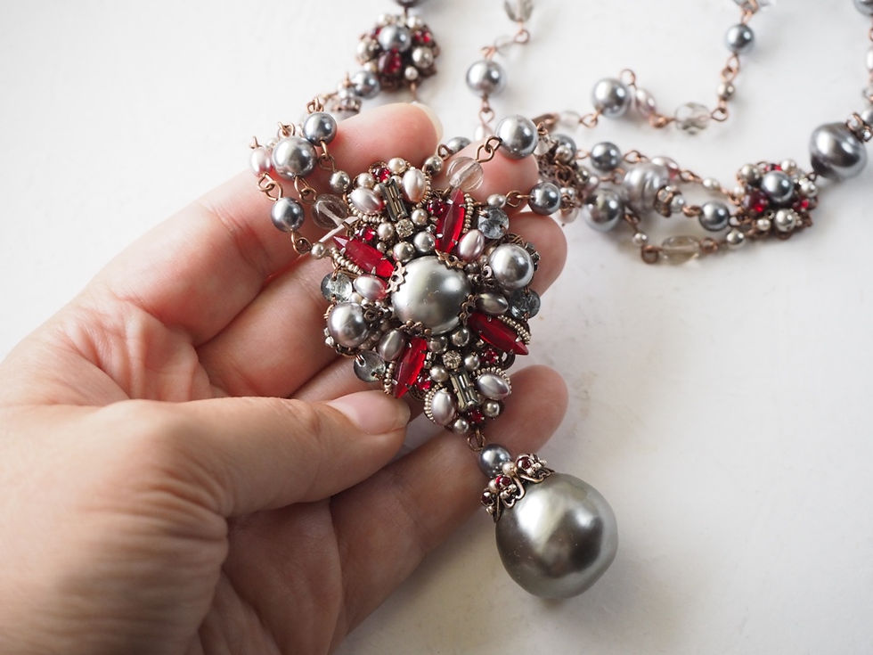 Thumbnail: hand holding necklace for size comparison