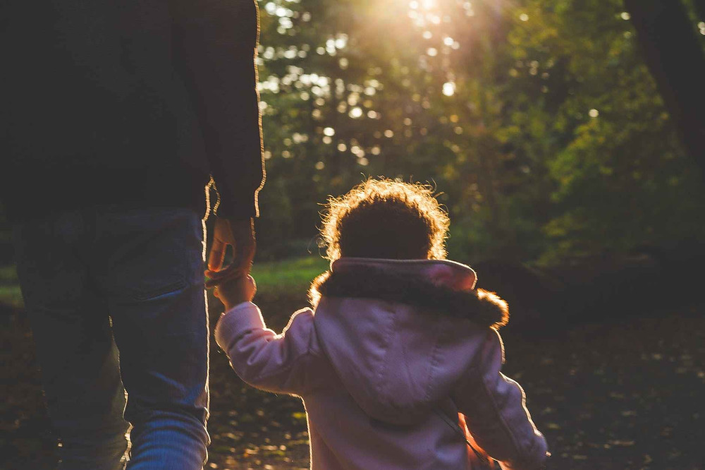 toddler in white hoodie during daytime