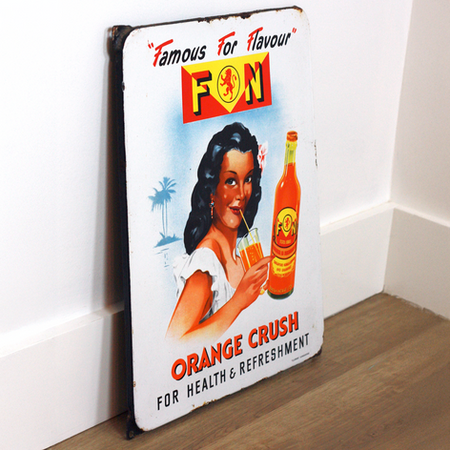 F&N Orange Crush sign angled showing lion logo, woman with bottle, Orange Crush text, and darkened corner mounts
