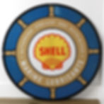 Round blue and tan porcelain sign, ship's wheel border, yellow Shell logo at center, 1950s porcelain gas and oil sign