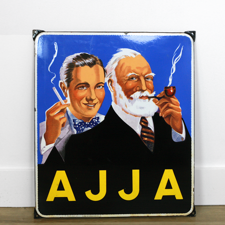 Blue AJJA sign showing two men - elder with white beard and pipe, younger with bow tie and cigarette - with Tabacs text and French advertising