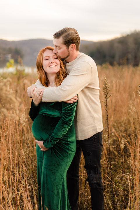 maternity photo of expecting couple in a field of tall grass in the fall melton hill knoxville tn / photo by Knoxville maternity and newborn photographer Wood Shutter Photography