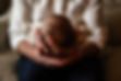 newborn baby is held in dads hands during Knoxville TN lifestyle newborn portrait session photo by Knoxville maternity, newborn, and family photographer Wood Shutter Photography