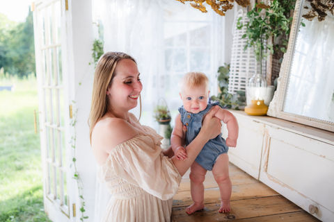 mother holding baby girl during Knoxville TN family portrait session photo by Knoxville maternity, newborn, and family photographer Wood Shutter Photography
