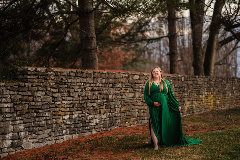 fall maternity photo of woman in a green maternity dress at knoxville botanical garden / photo by knoxville maternity and newborn photographer wood shutter photography / see more at woodshutterphotography.com