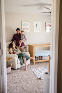 family in nursery with newborn baby during Knoxville TN lifestyle newborn portrait session photo by Knoxville maternity, newborn, and family photographer Wood Shutter Photography