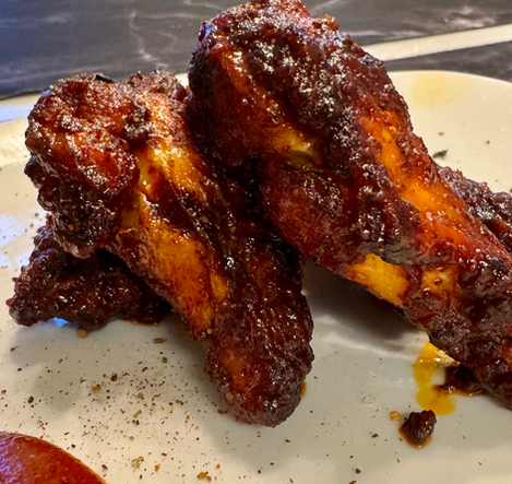 Gochujang Ember Wings: Inspired by Korean street flavors, these wings are glazed with rich gochujang chili paste. Sweet, spicy, and packed with umami.