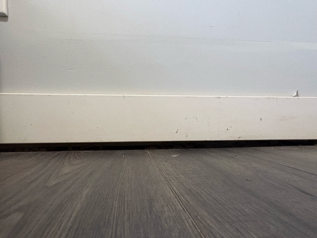 a gap between the floor and wall due to sinking.