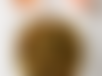 Overhead view of garlic herb roasted mushrooms on a white square plate, with a glass of wine and a pink rose on a clean white background.