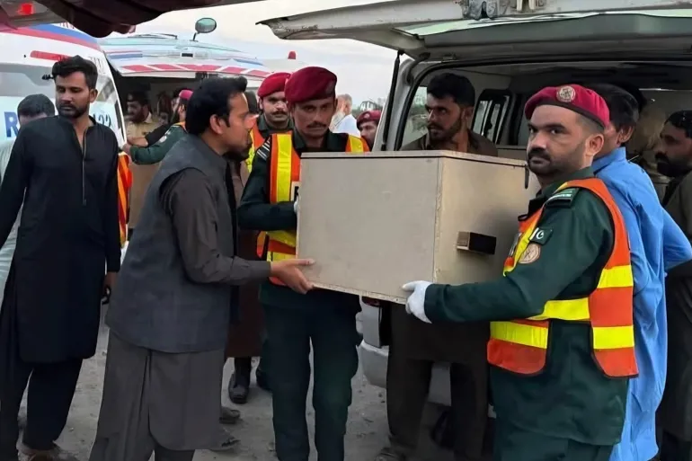 A casket containing the body of a passenger, killed during bus attacks by gunmen in southwestern Pakistan is unloaded by rescue workers and volunteers from an ambulance upon arrival in Dera Ghazi Khan, Friday, July 11, 2025 [Rescue 1122 Emergency Department via AP]