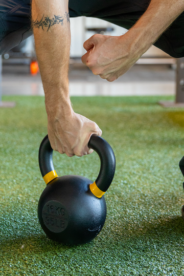 chris holding a kettlebell  at lift wellness space.