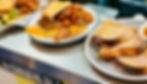three plates with breakfast foods at a restaurant